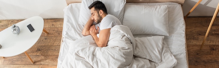 person sleeping on side in bed