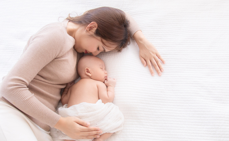 person sleeping with baby in bed after c-section