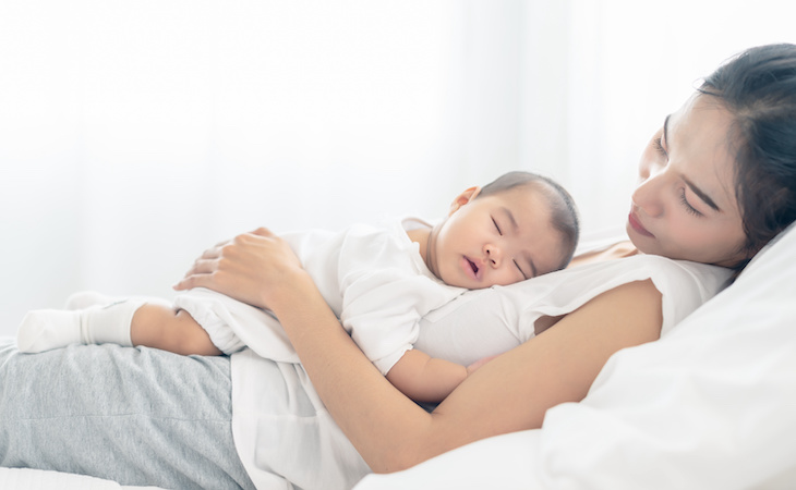 tired mom holding baby
